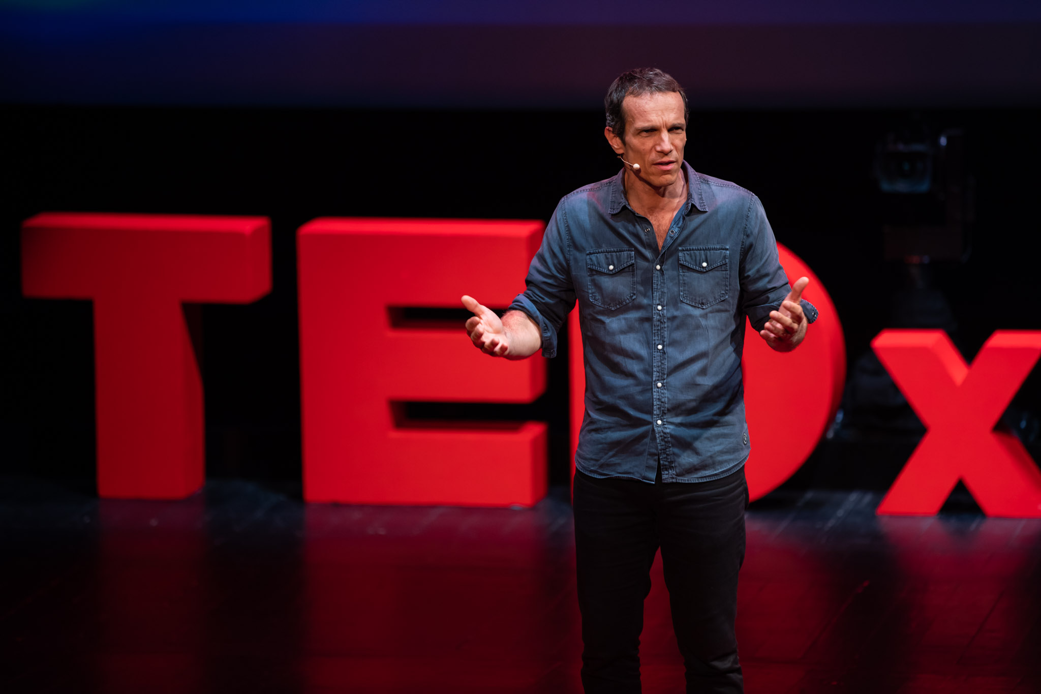 Man standing in front of TEDx sign
